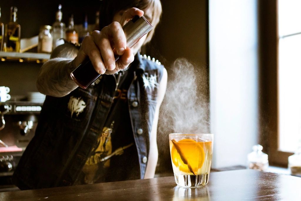 A cocktail being finished at the bar