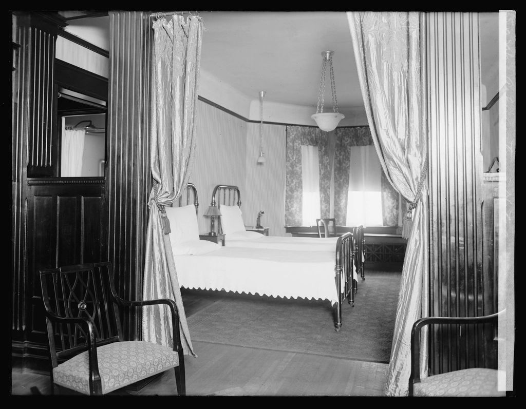 A guest room with two beds and a window